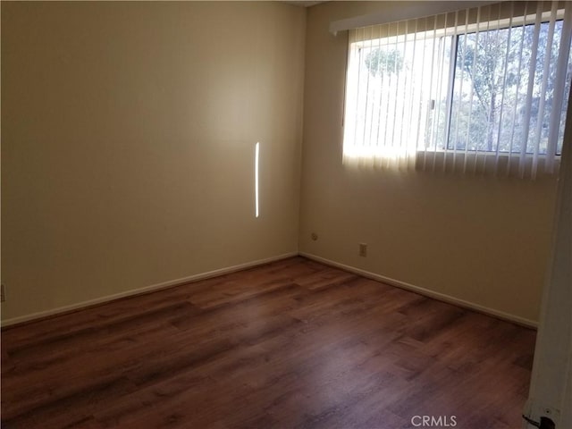 empty room with dark hardwood / wood-style floors