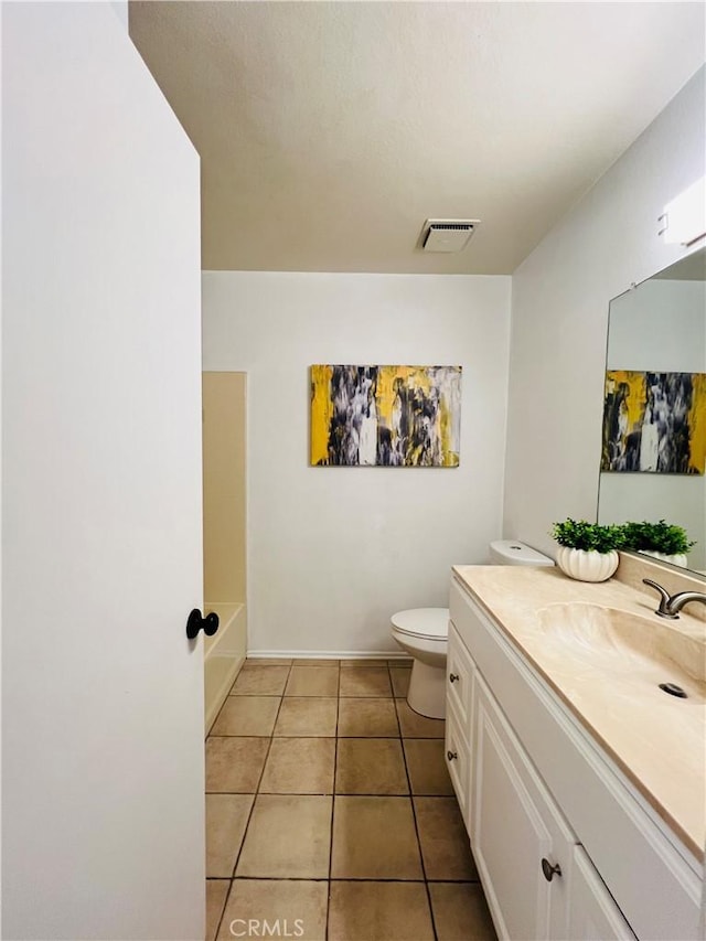 bathroom featuring tile patterned floors, toilet, and vanity