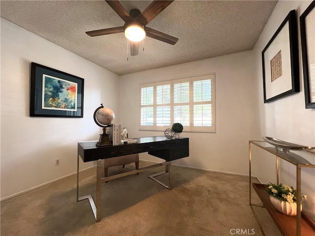 carpeted office space with ceiling fan and a textured ceiling