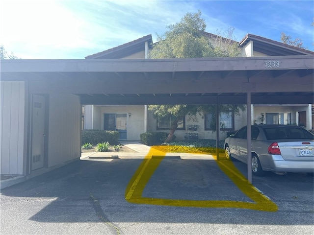 view of vehicle parking featuring a carport