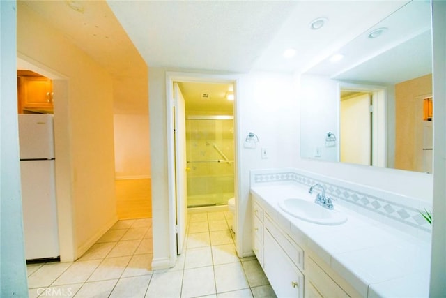 bathroom featuring a shower with door, vanity, tile patterned floors, and toilet