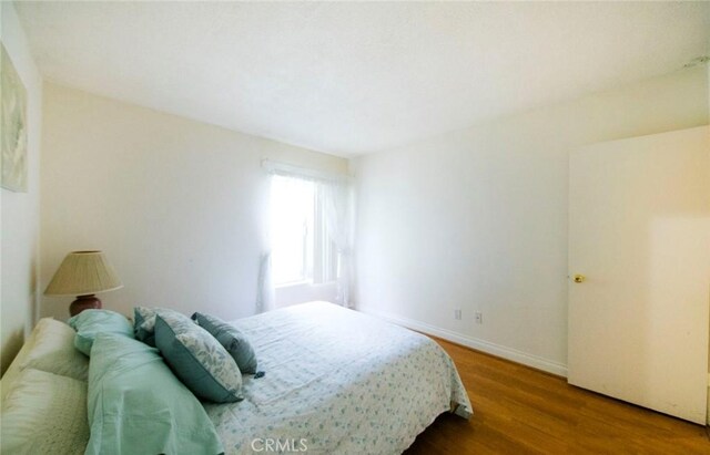 bedroom with hardwood / wood-style flooring