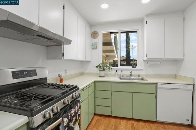 kitchen with sink, light hardwood / wood-style flooring, dishwasher, green cabinets, and stainless steel gas stove