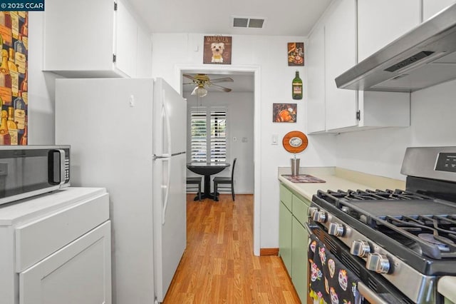 kitchen featuring light hardwood / wood-style flooring, ceiling fan, white cabinetry, range hood, and stainless steel appliances