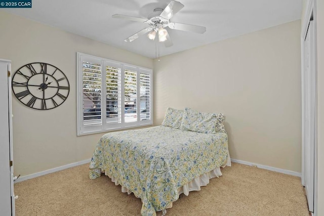 carpeted bedroom featuring a closet and ceiling fan