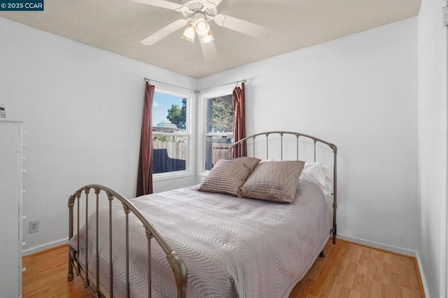 bedroom with ceiling fan and light hardwood / wood-style floors