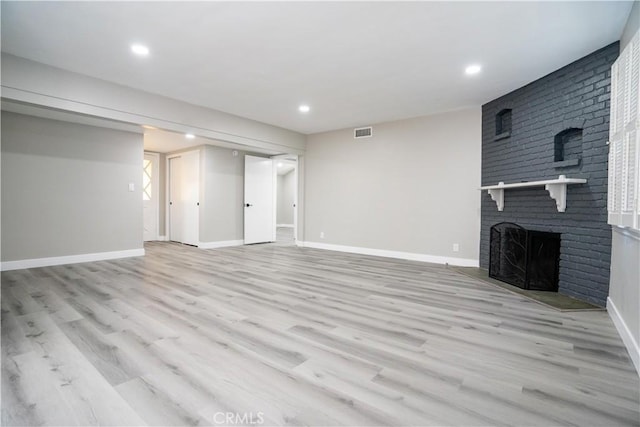 interior space featuring light hardwood / wood-style flooring and a fireplace