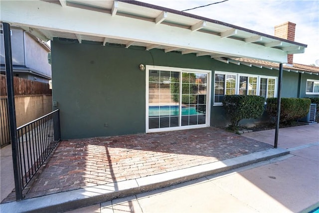 property entrance featuring a patio