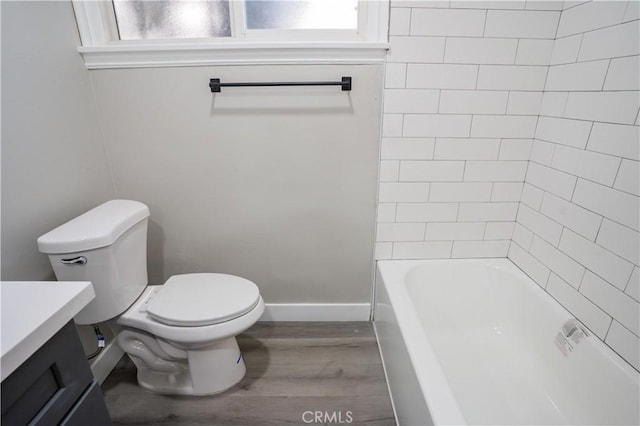 bathroom featuring vanity, a wealth of natural light, wood-type flooring, and toilet