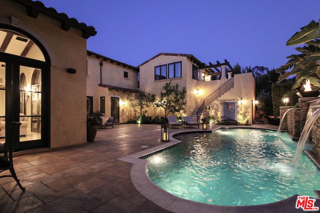 view of pool with pool water feature and a patio area