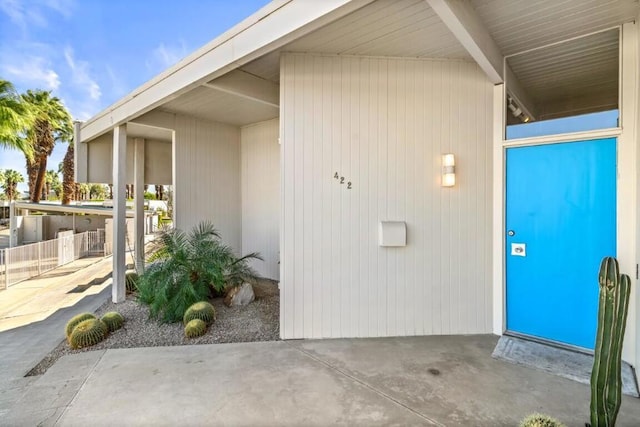 view of exterior entry with a carport