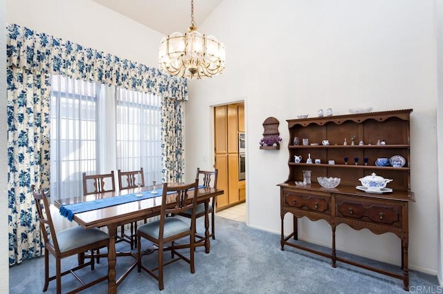 carpeted dining area with vaulted ceiling and a notable chandelier