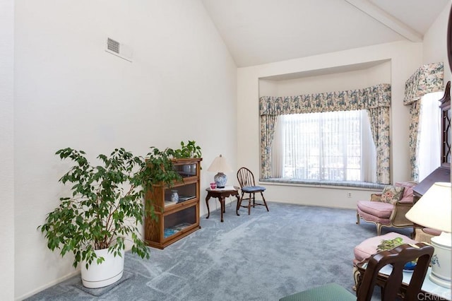 sitting room with vaulted ceiling and carpet floors