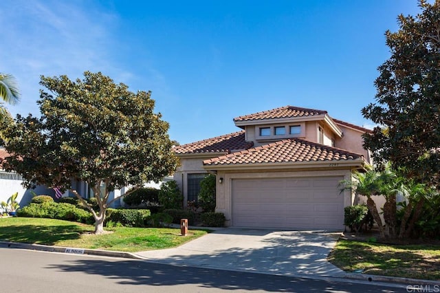 mediterranean / spanish-style home featuring a garage and a front lawn