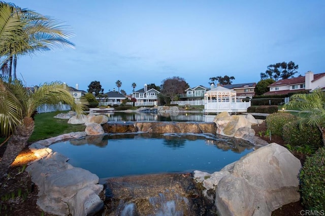 view of swimming pool with a water view