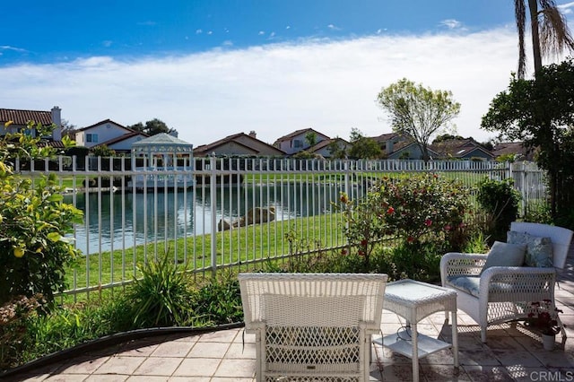 view of patio / terrace featuring a gazebo and a water view