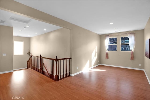 unfurnished room with hardwood / wood-style floors