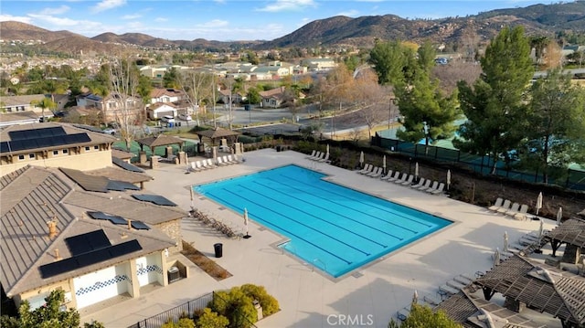 view of swimming pool featuring a mountain view and a patio area