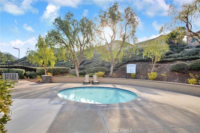 view of pool featuring a mountain view and a patio area