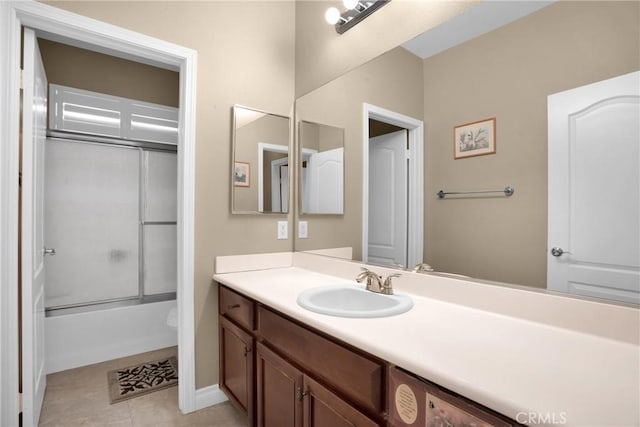 full bathroom with vanity, tile patterned flooring, shower / bath combination with glass door, and toilet