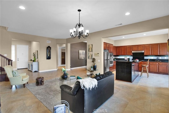 living room with light tile patterned floors and a notable chandelier