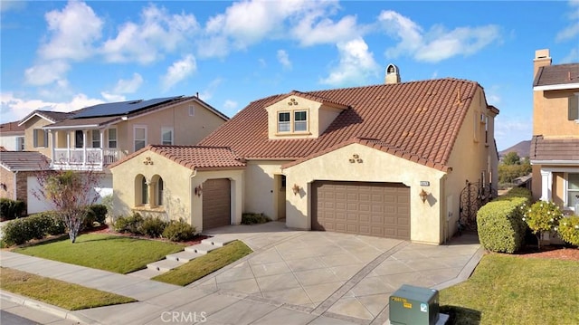 mediterranean / spanish-style house with a garage and a front yard