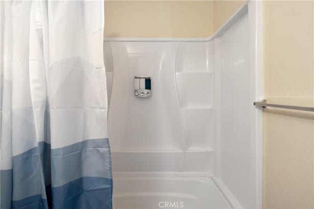 bathroom with shower / bath combination with curtain