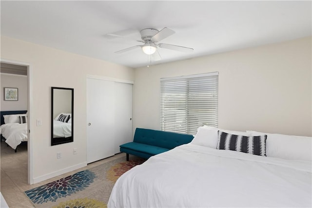 bedroom with ceiling fan and a closet