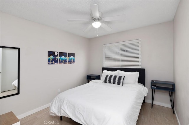 bedroom featuring ceiling fan and light hardwood / wood-style floors