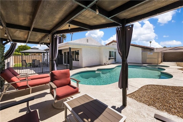 view of swimming pool featuring a gazebo, an in ground hot tub, and a patio area