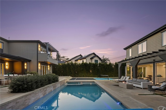 pool at dusk with a pergola, an outdoor hangout area, a patio, and an in ground hot tub