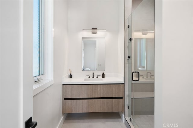 bathroom with a shower with door and vanity