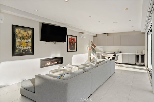 living room featuring light tile patterned flooring, wine cooler, and a wall unit AC