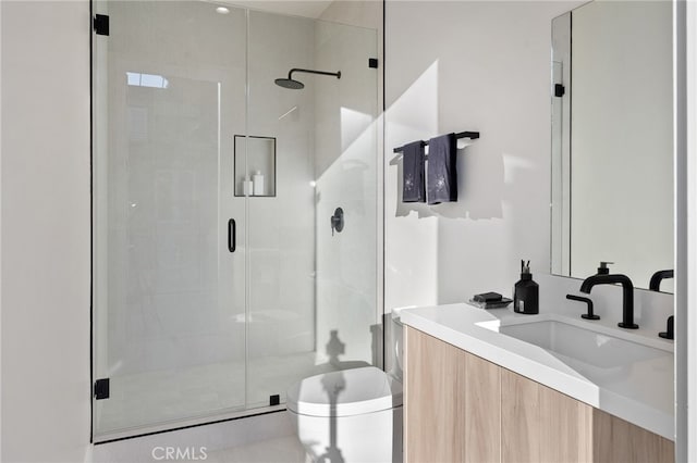 bathroom with vanity and a shower with shower door