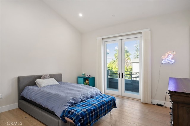 bedroom featuring french doors, lofted ceiling, access to exterior, and light wood-type flooring