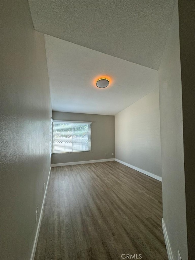 empty room featuring dark wood-type flooring