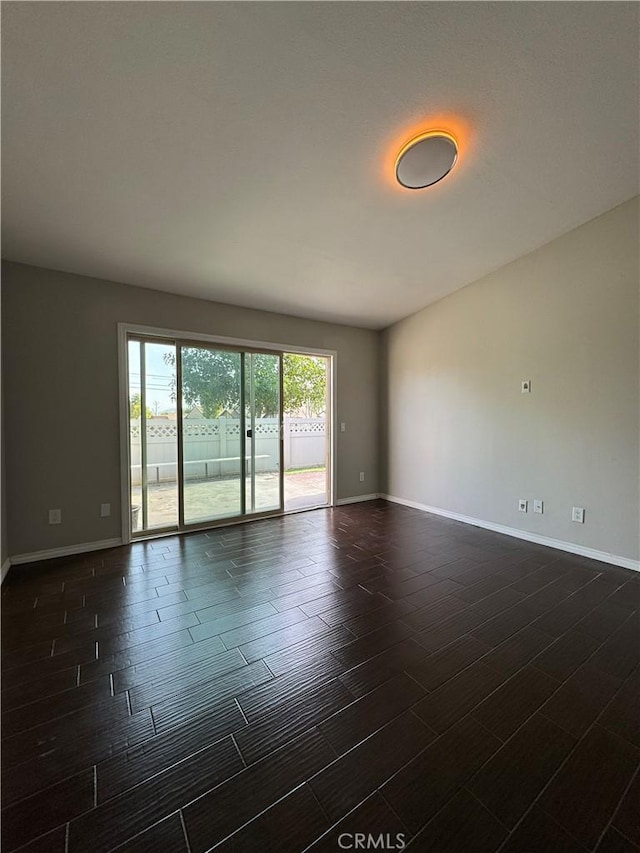 spare room with dark hardwood / wood-style flooring