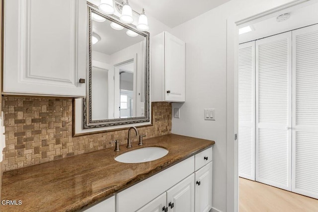 bathroom featuring tasteful backsplash and vanity