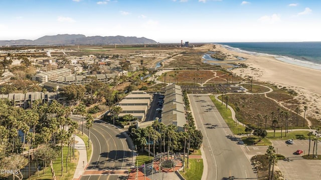 bird's eye view featuring a water and mountain view and a beach view