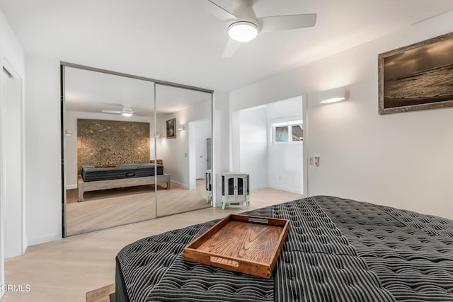 bedroom with ceiling fan, hardwood / wood-style floors, and a closet