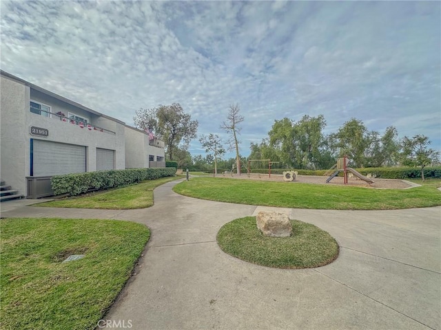 view of community featuring a yard and a playground