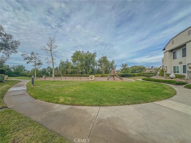 surrounding community featuring a yard and a playground