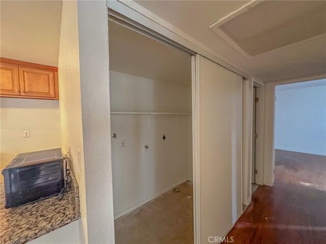 hallway featuring dark colored carpet