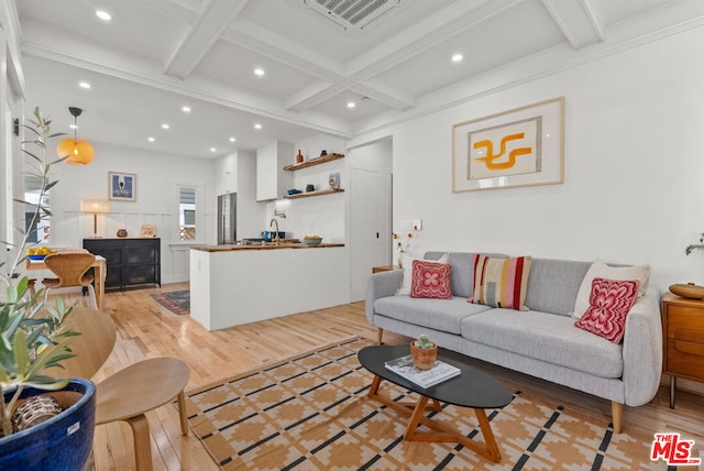 living room featuring coffered ceiling, sink, light hardwood / wood-style flooring, and beamed ceiling