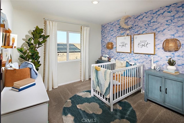 carpeted bedroom featuring a crib