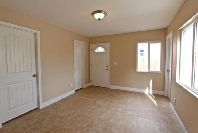 entryway with plenty of natural light and light tile patterned floors