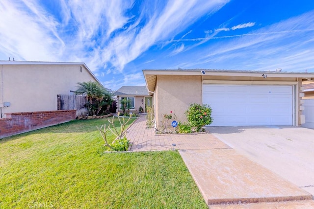 exterior space with a garage and a lawn