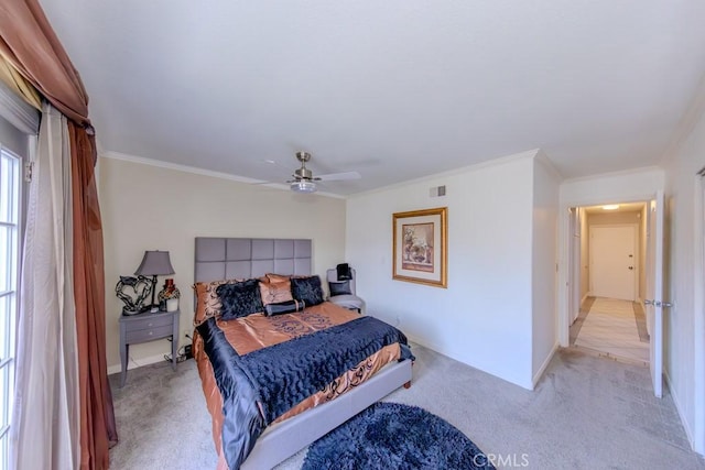 bedroom featuring crown molding, light colored carpet, and ceiling fan