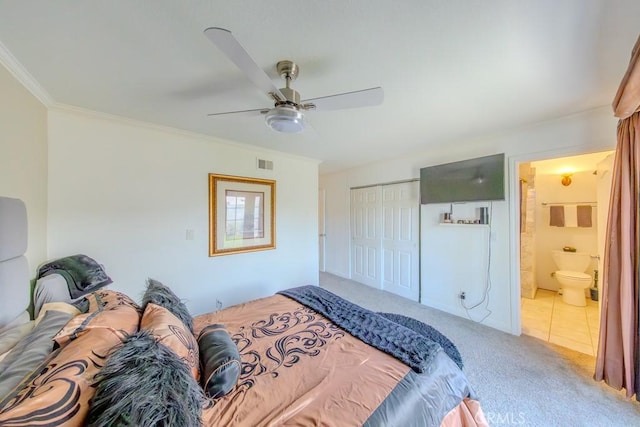 bedroom with ensuite bath, ornamental molding, carpet floors, a closet, and ceiling fan