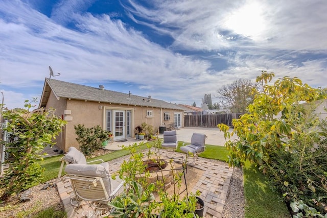 rear view of property featuring a patio, central AC, and french doors